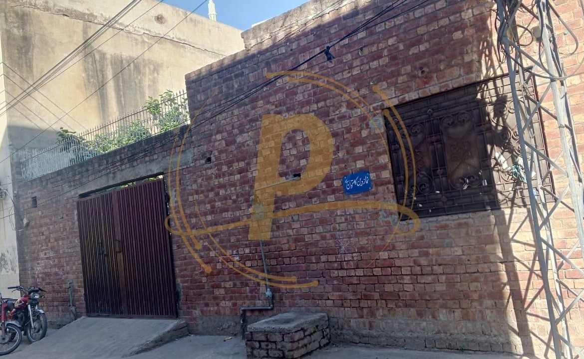 a brick building with a letter painted on it