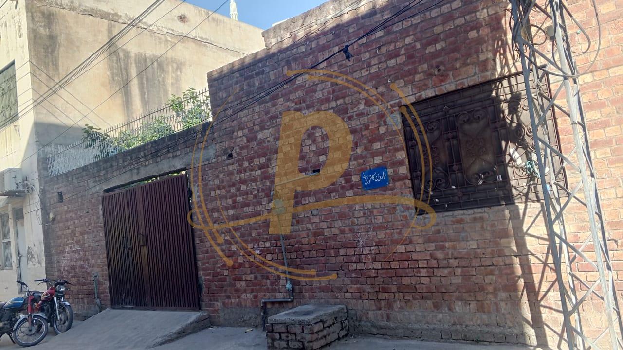 a brick building with a letter painted on it