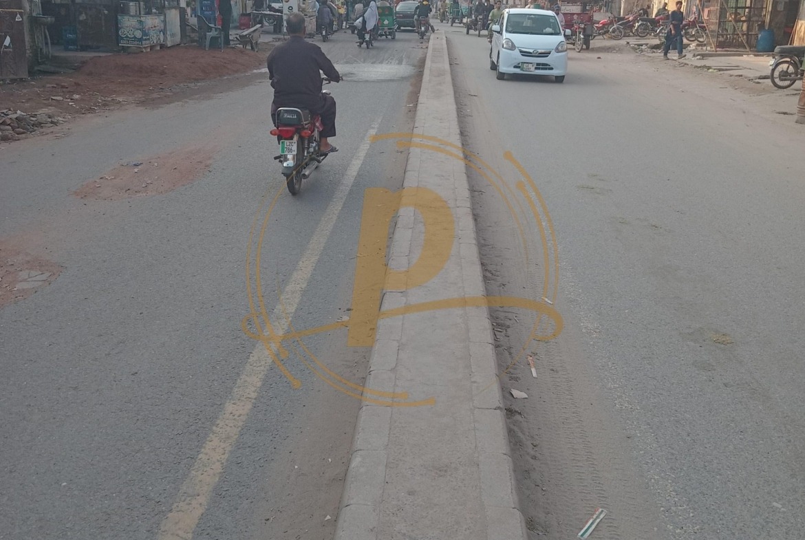 a man riding a motorcycle on a street